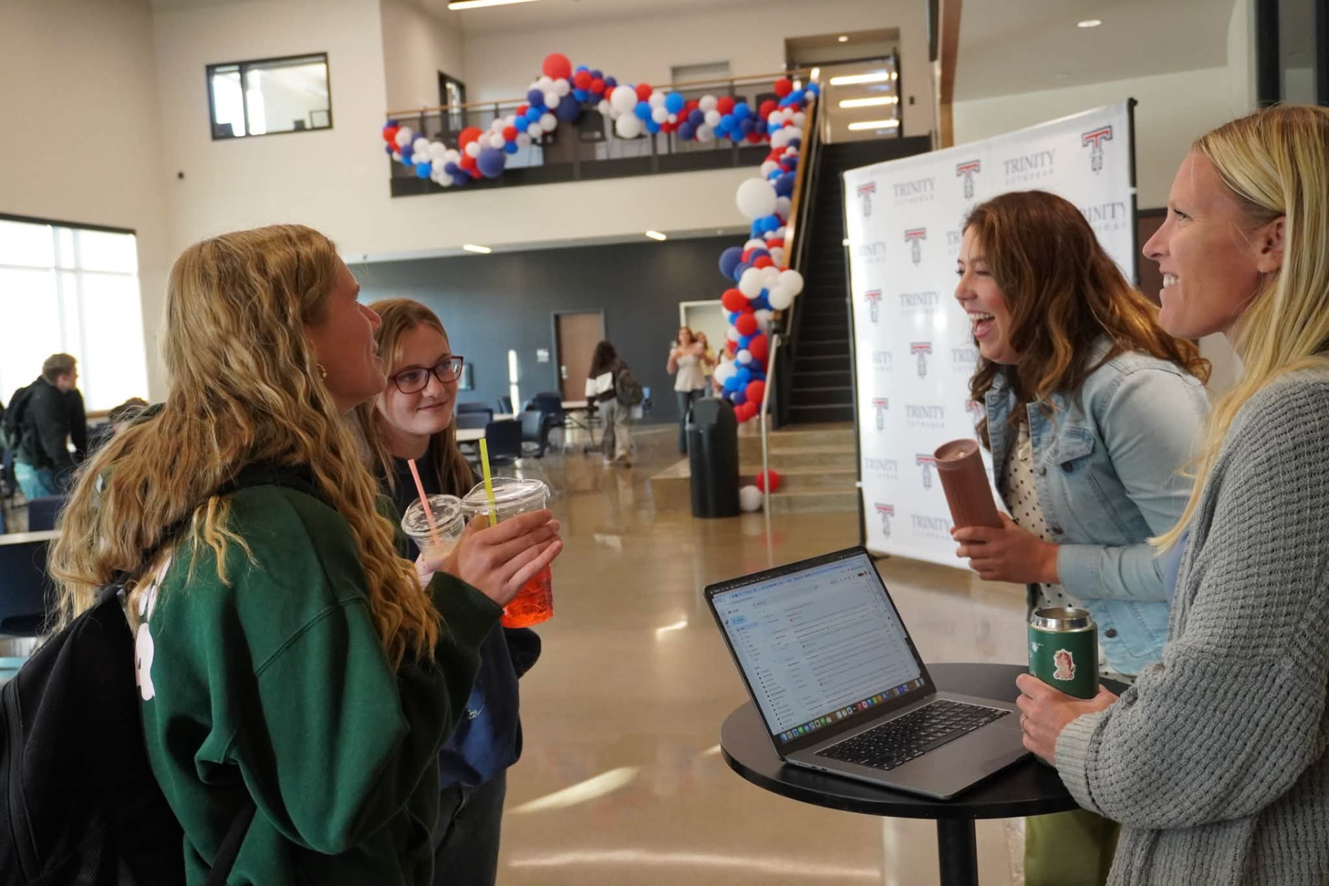Trinity students and staff laughing together at a school welcome event