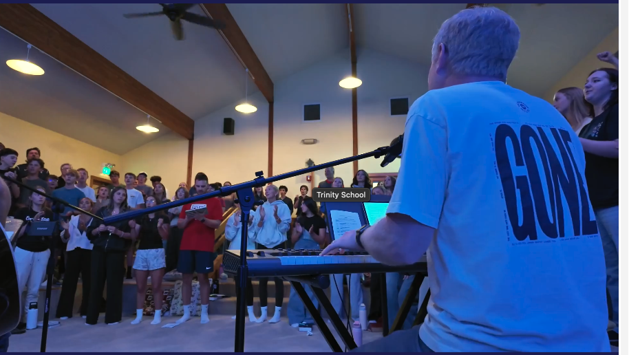 Trinity students singing during a worship night led from the keyboard
