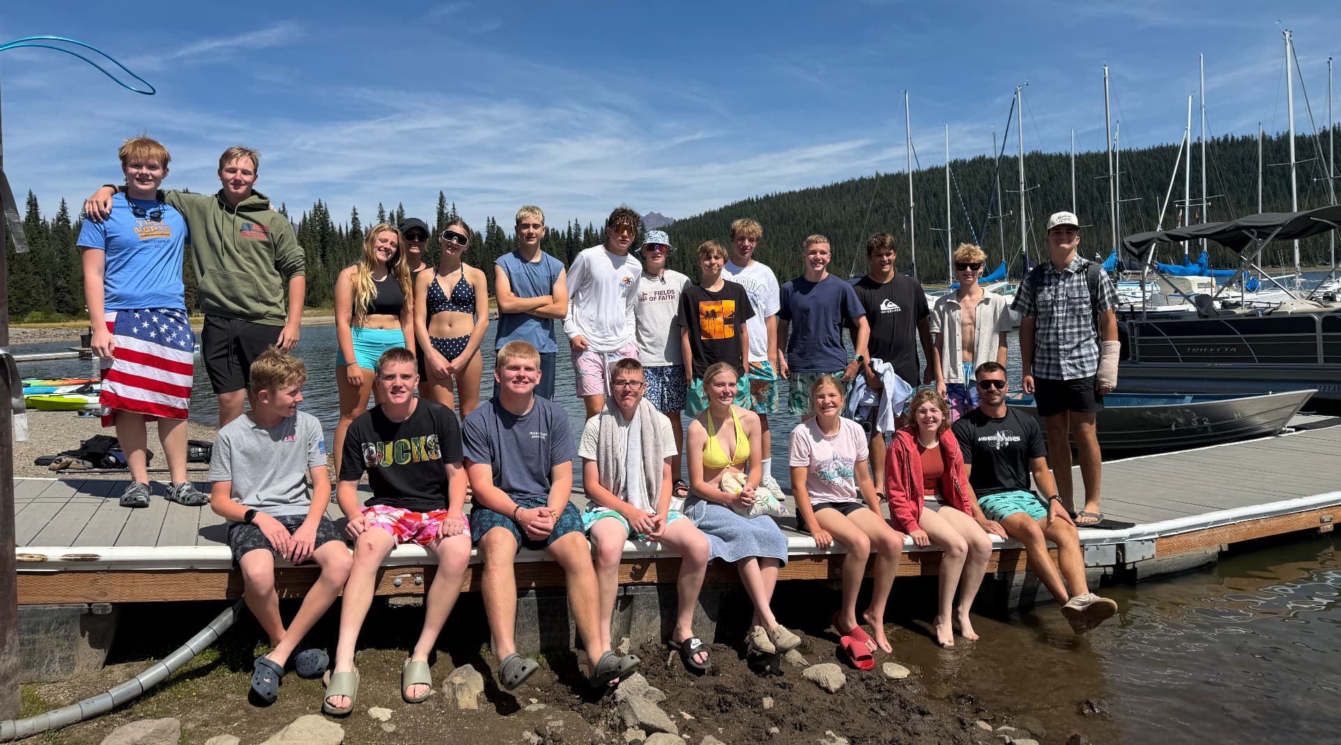 Trinity youth group gathered on a lake dock during a summer trip