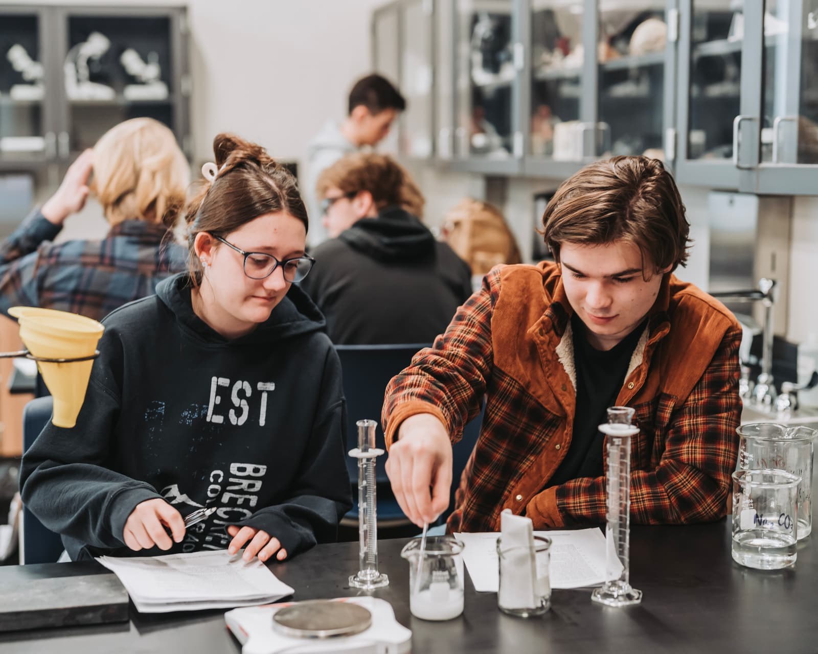 Two Upper School students working together on a chemistry experiment in the science lab