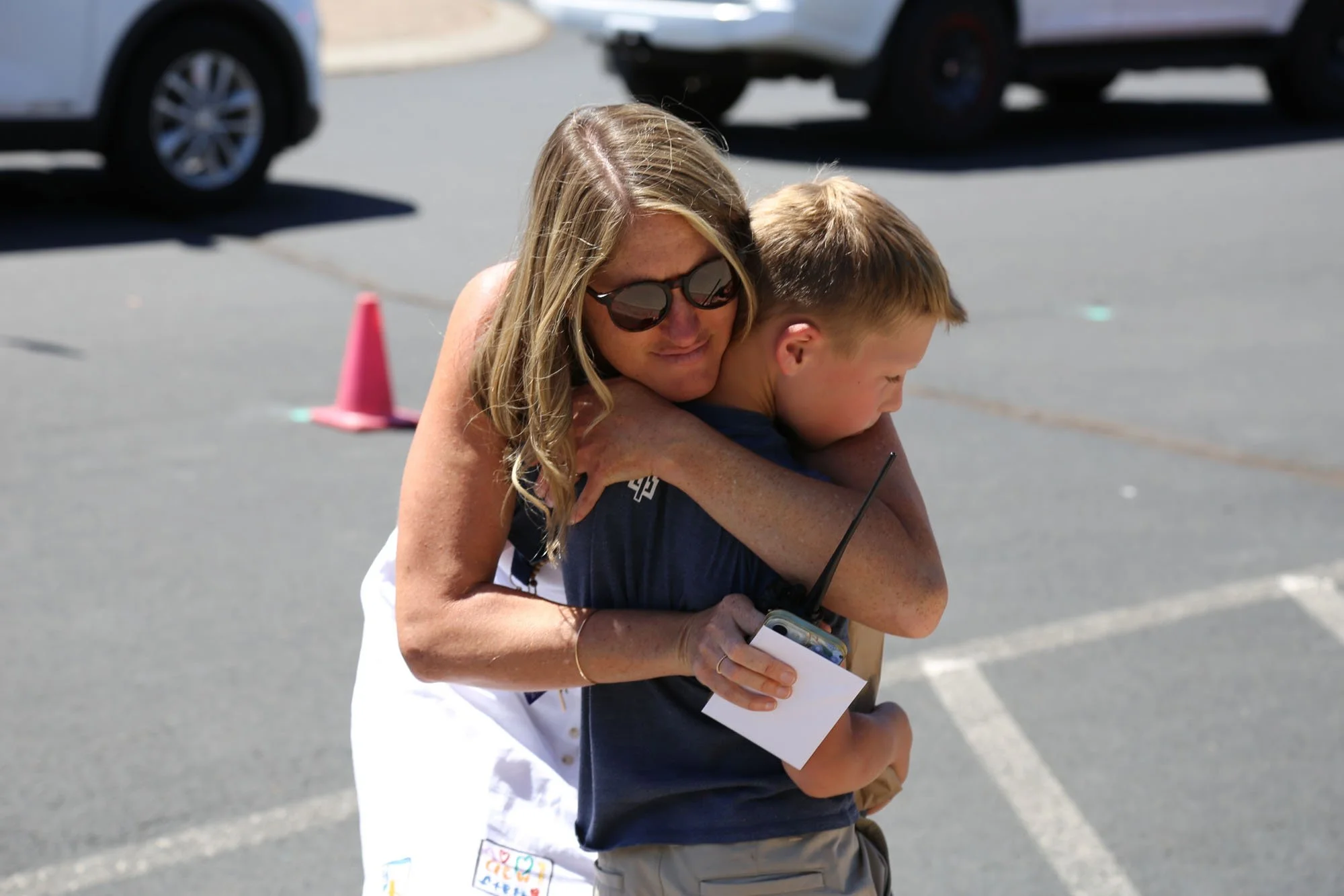 Trinity teacher hugging a student